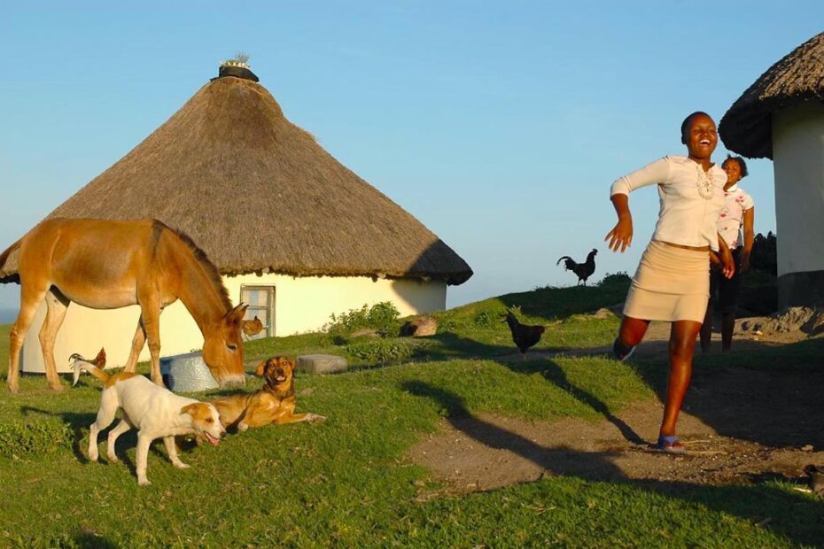 Woman running on a farm in South Africa, Wild Coast, Transkei by Amsterdam photographer Tom van der Leij